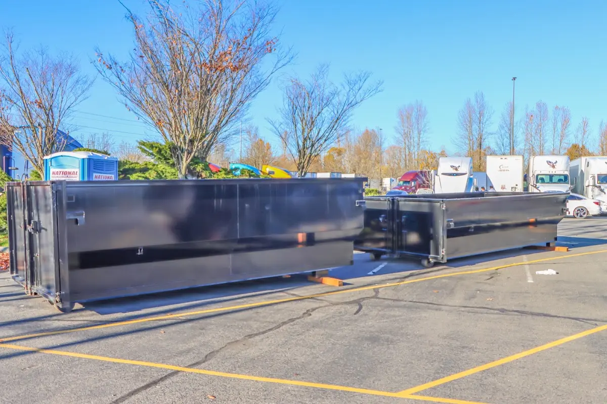 Professional dumpster rental service with roll-off container on residential driveway in Broomfield